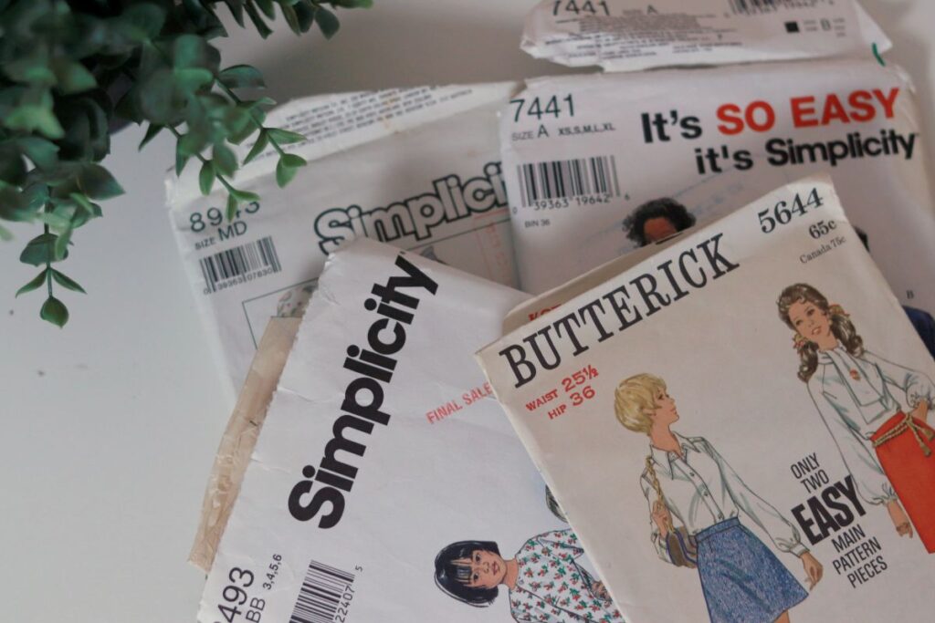 vintage sewing patterns laying on white surface