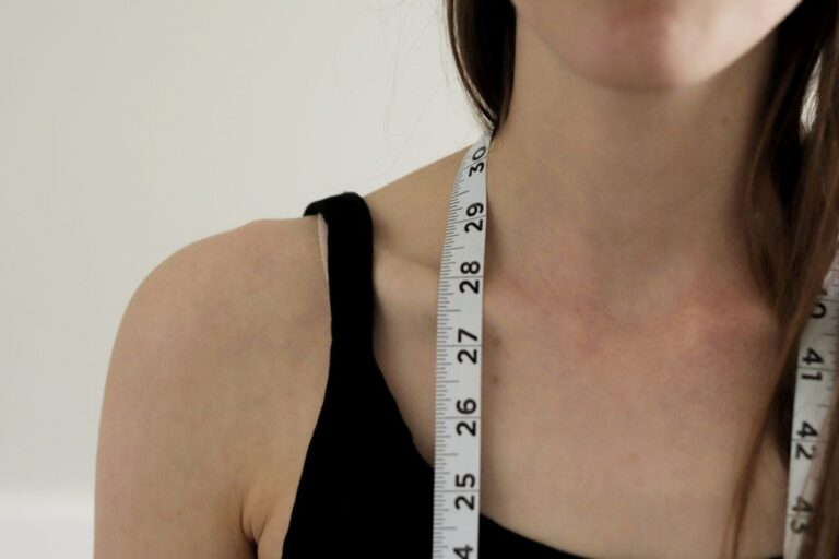 woman with measuring tape around her neck