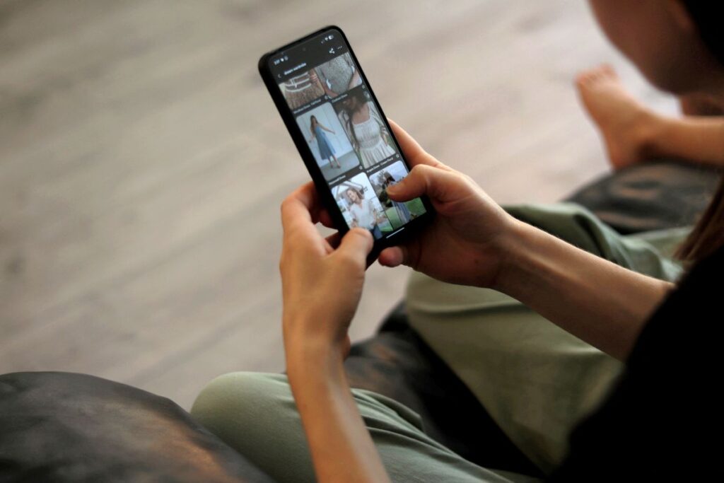 woman scrolling through Pinterest clothing board