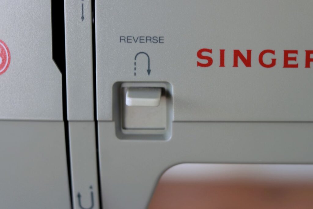 sewing machine reverse button