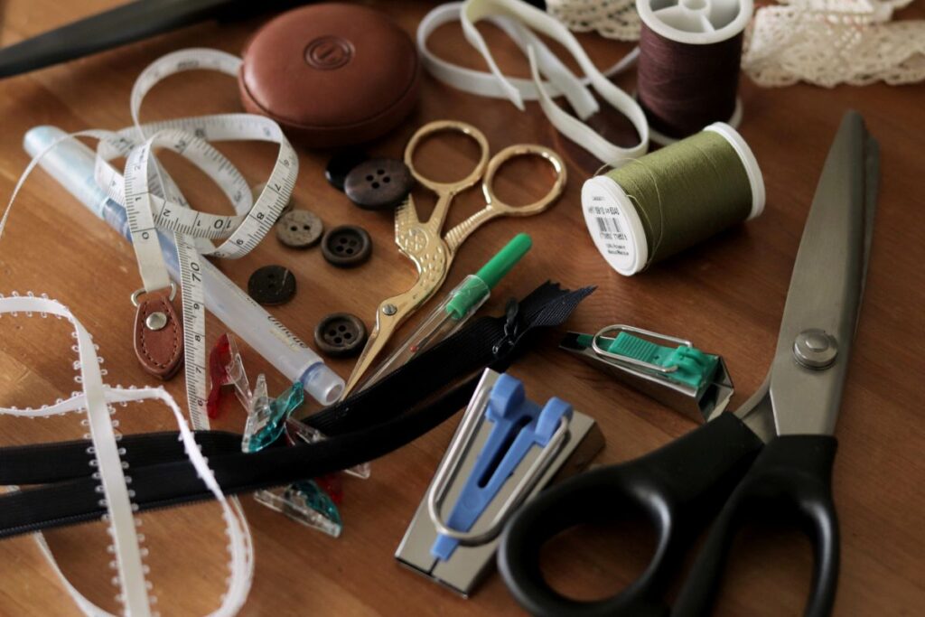 assorted sewing notions lying scattered on table